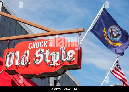 Neon sign outside Chucks famous bar restaurant in Fontana on Lake Geneva, Wisconsin, America.with the American flag and the flag of the US navy in the Stock Photo