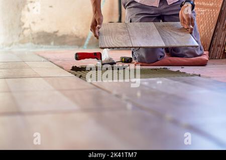 Installing ceramic floor Stock Photo