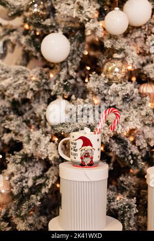 New Year's Cup with Marshmallow and Lollipop on a Gift Box Stock Photo