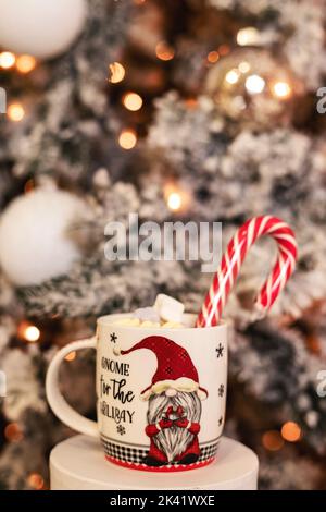 New Year's Cup with Marshmallow and Lollipop on a Gift Box Stock Photo