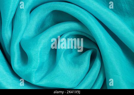 Fabric twisted in spiral waves, fashion trendy tourmaline color Stock Photo