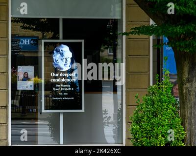Tribute on Queen's death (poignant electronic digital shop front image, Elizabeth 2 II face, remembering commemorating, paying respects) - England UK.