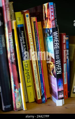 Books on shelf close-up. Library with bookcases. Many different books on the shelves. Large selection of books in a bookcase. Nobody-September 27,2022 Stock Photo
