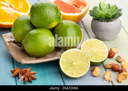 sliced lime on a plate on wood background Stock Photo