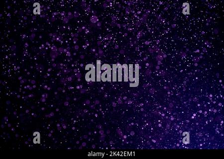 Dust blue particles on black background. Glittering sparkling bokeh overlay with copy space for text. Stock Photo