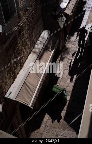 street cleaner with brush early morning in a narrow street Dubrovnik Stock Photo