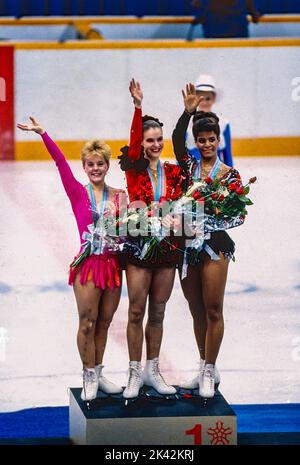 Katarina Witt (GDR) Gold medalist and Olympic Champion with Elizabeth Manley (CAN)-L- silver medalist and bronze medalist Debi Thomas (USA) in the Ladies Figure Skating at the 1988 Olympic Winter Games. Stock Photo