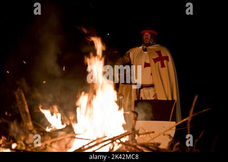 Templar Knight by fire, burning perhaps of fallen brothers in arms. Stock Photo