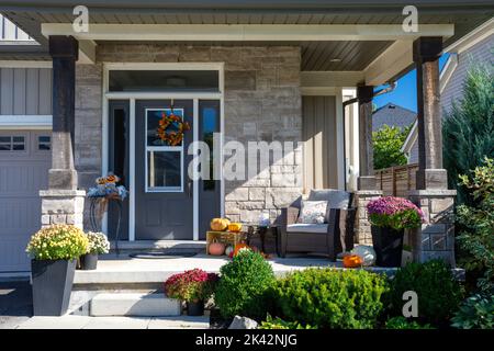 Colourful pumpkins, gourds and mums create a luxury halloween and thanksgiving landscaping decor. Stock Photo
