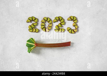 Freshly chopped Rhubarb in the form of 2023 on white background , vegetarian New year concept, top view, card Stock Photo