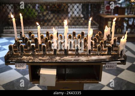 Votive Candles in the Basilica della Santissima Annunziata (Basilica of the Most Holy Annunciation) Florence Italy Stock Photo