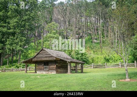 Wood barn structure sitting in Stone Mountain State Park with a forest behind in the summer. Stock Photo