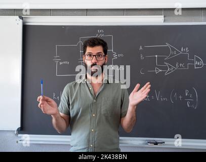Spanish male teacher explaining the science lesson Stock Photo