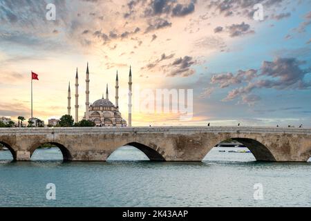 Sabanci Central Mosque and Stone bridge in Adana, Turkey, and the view of Seyhan river with sunset sky. Landmarks in the city of Adana, Turkey Stock Photo