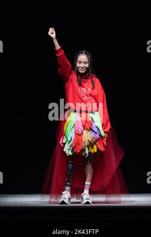 SHANGHAI, CHINA - SEPTEMBER 29, 2022 - Niu Yu, a Wenchuan earthquake survivor, walks with a mechanical leg as she completes the Pony brand runway show Stock Photo