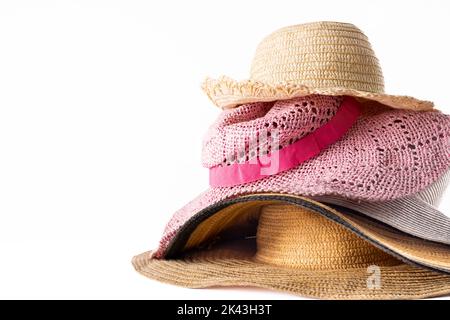 Image of stack of straw hats on white surface Stock Photo