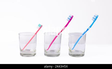 Image of toothbrushes in glasses on white background Stock Photo