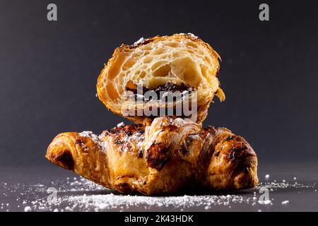 Image of croissants with chocolate on dark grey surface Stock Photo