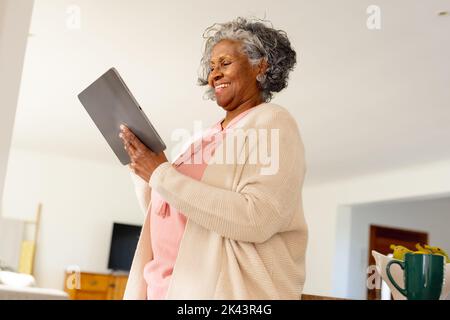 Happy senior african american women standing and using tablet Stock Photo