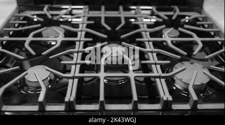 Kitchen surface in stainless steel with cast iron grill. View from above. Stove hob cooking kitchen cooker metal burner gas kitchen electric hot cookt Stock Photo