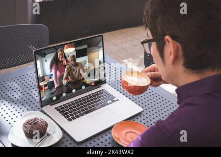 Asian businessman having video call with colleagues. Global business and digital interface concept, digital composite image. Stock Photo