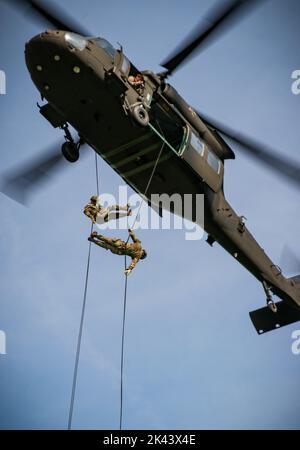 U.S. Soldiers rappel from a UH-60 Black Hawk helicopter at Camp Dodge in Johnston, Iowa, on Sept. 14, 2022. Nearly 30 Soldiers and Airmen participated in a Rappel Master course hosted by a mobile training team from the Army National Guard Warrior Training Center based out of Fort Benning, Georgia. (U.S. Army National Guard photo Staff Sgt. Tawny Kruse) Stock Photo