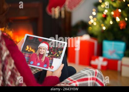Redhead using tablet computer at christmas at home in the living room Stock Photo