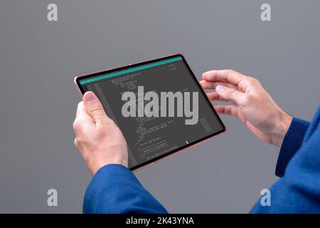 Hands of caucasian male programmer using tablet with coding on screen. coding, programming and computer technology digital composite image. Stock Photo