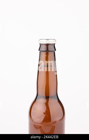 Image of brown glass full lager beer bottle with crown cap, with copy space on white background Stock Photo