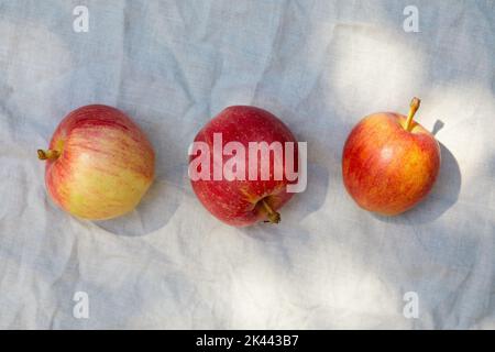 Overhead view of three ripe red and yellow apples Stock Photo