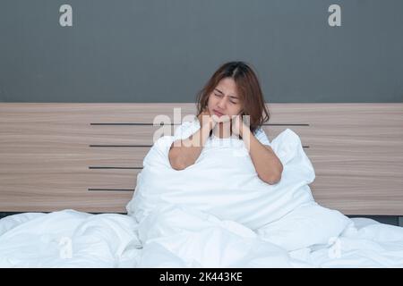 Pain in the shoulder and neck. Upper shoulder pain, People with body-muscles problem, Healthcare And Medicine concept. Attractive woman on the bed and Stock Photo