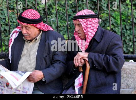 Elderly Palestinian men reading the morning newspaper at Stock Photo