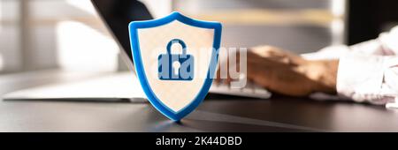 African American Man Using Secure Computer. Shield Sign Stock Photo