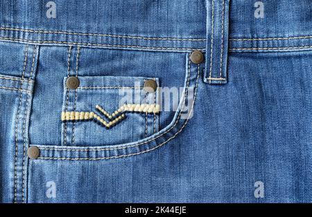 Fragment of jeans with a pocket. Casual wear. Original background for the design. Stock Photo