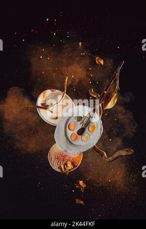 Autumn art concept, diy palettes, artist tools in an explosion of sparkles and cinnamon, cloud of color Stock Photo