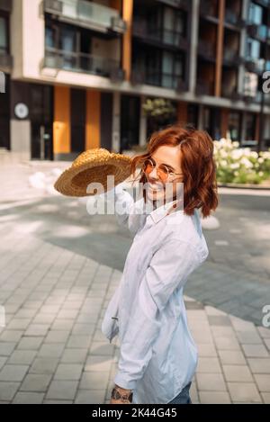 A red-haired woman poses for the camera Stock Photo