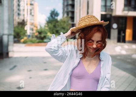 A red-haired woman poses for the camera Stock Photo