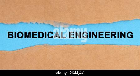 Medicine concept. The paper is ripped in the middle. Inside on a blue background it is written - Biomedical Engineering Stock Photo