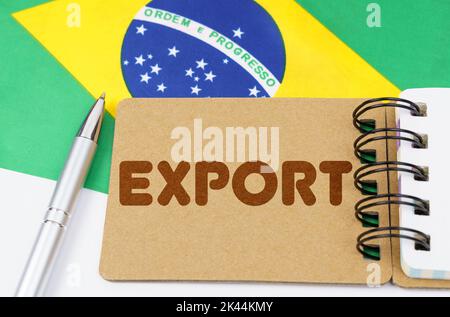 National economy concept. On the flag of Brazil lies a notebook with the inscription - export Stock Photo