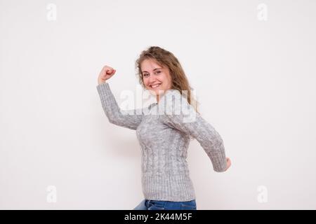 Laughing Young Woman Shows Arm Muscle - Stock Image Stock Photo