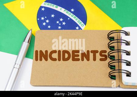 Politics and people concept. On the flag of Brazil lies a notebook with the inscription - incidents Stock Photo