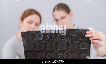 Female doctor explaining mri of internal organs to female patient.  Stock Photo