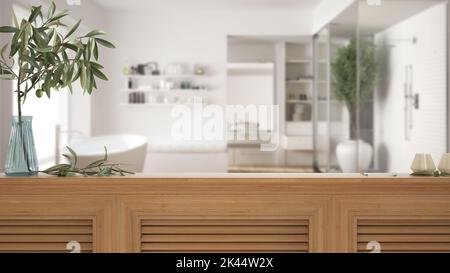 Wooden table top, cabinet, panel or shelf with shutters close up. Olive branch in vase and candles. Blurred background with modern bathroom with batht Stock Photo