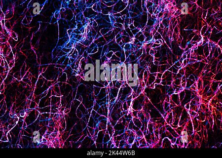 Wire abstract background. Green and red colors. No beggining or end. Made from wash cloth. Macro photo. Stock Photo