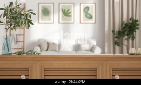 Wooden table top, cabinet, panel or shelf with shutters close up. Olive branch in vase and candles. Blurred background with white living room with sof Stock Photo