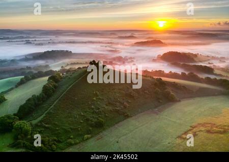 View from the air of a misty autumn sunrise at Colmers Hill at Symondsbury near Bridport in Dorset. Stock Photo