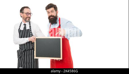 Opening soon. Men bearded bartender or cook in apron hold blank chalkboard. Workers wanted. Bartender with blackboard. Hipster bartender show Stock Photo
