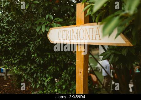 Wooden sign reading "Ceremony" in italian during wedding day celebrations. Detail of wedding decorations Stock Photo