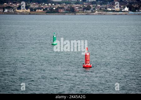 green and red navigation markers in the shipping lanes channel in the middle of belfast lough northern ireland Stock Photo