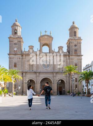Cathedral of Saint Ana, Las Palmas de Gran Canaria, Spain, a couple of men and a woman on vacation in Gran Canaria walking in the old town of las Palmas.  Stock Photo